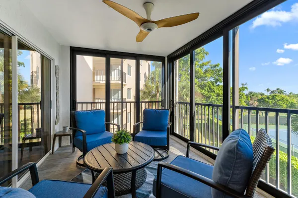 a living room with furniture and a floor to ceiling window
