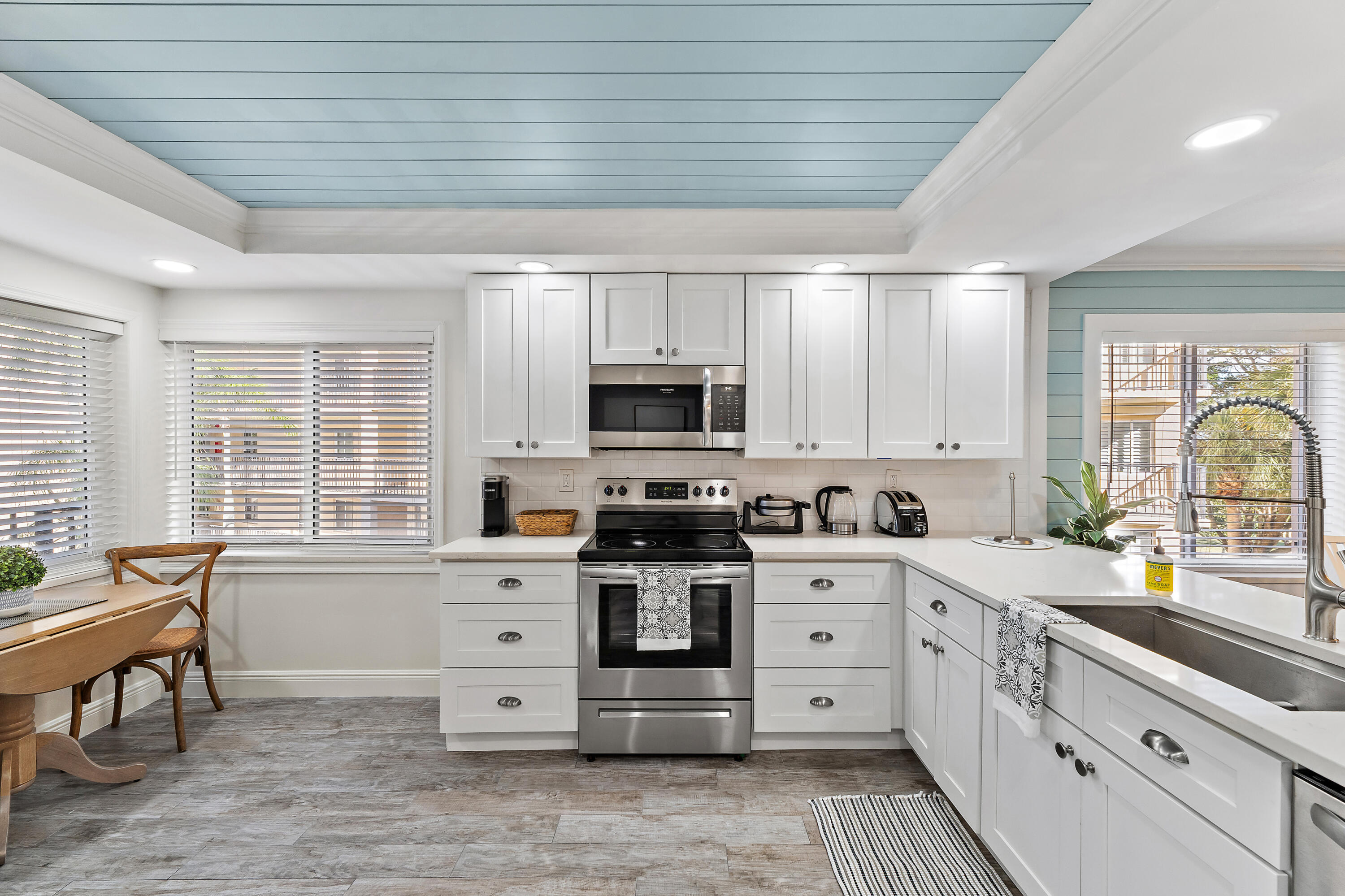 275 Palm Avenue, Unit A301 Jupiter, FL 33477 - Photo 4 of 38 a large kitchen with stainless steel appliances granite countertop a stove and a sink