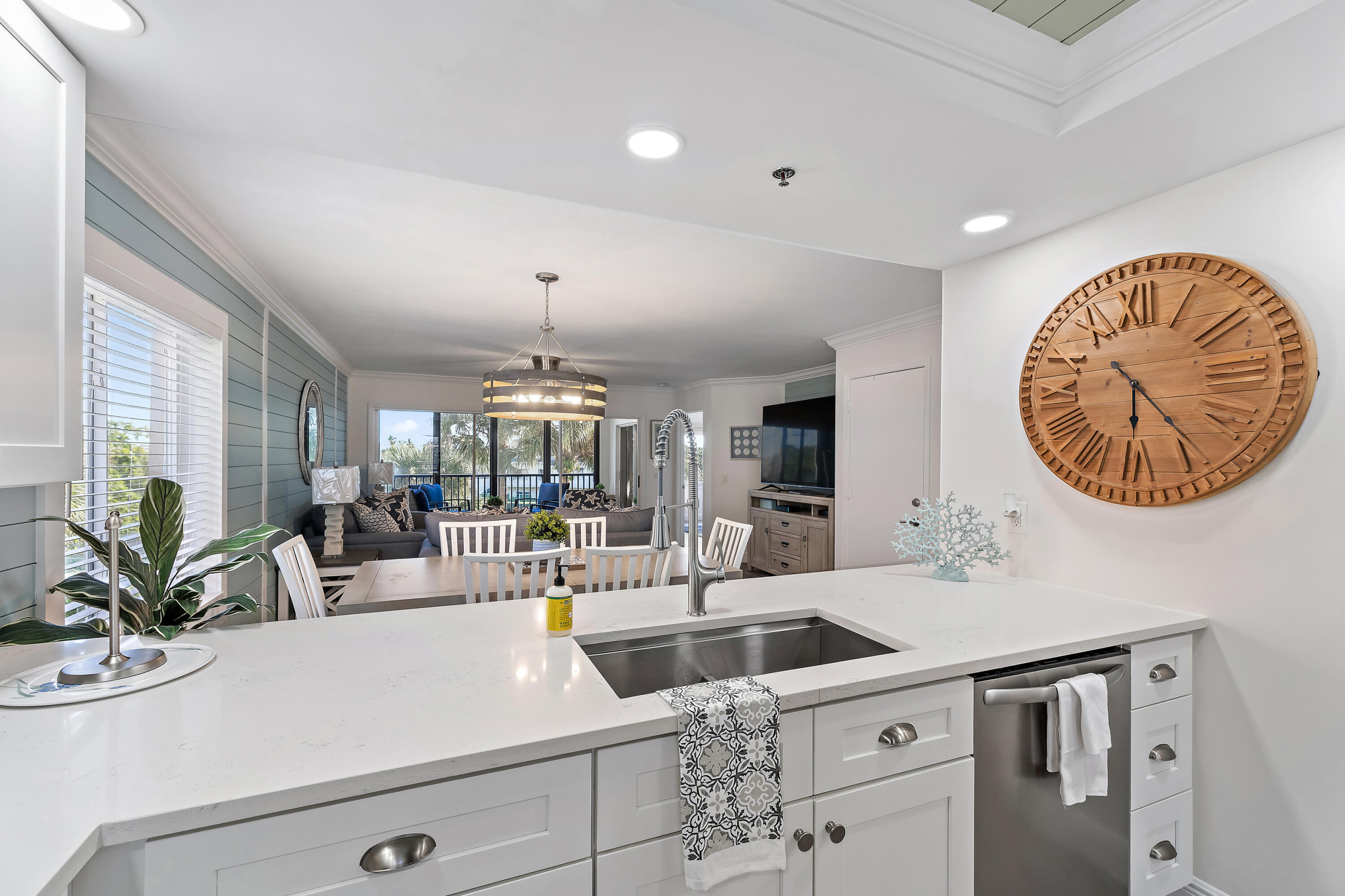 275 Palm Avenue, Unit A301 Jupiter, FL 33477 - Photo 6 of 38 a kitchen with a sink a chandelier and living room view