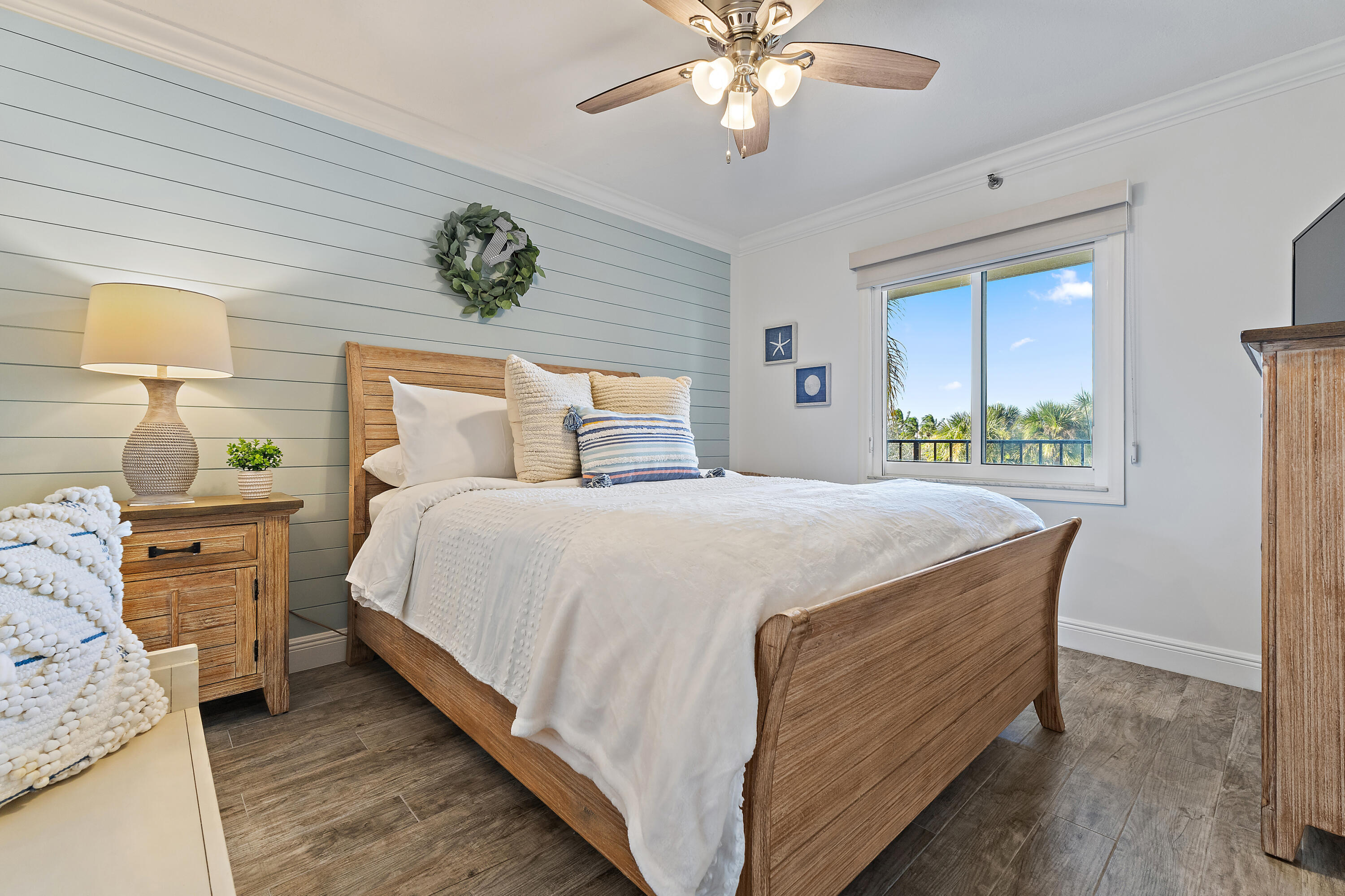 275 Palm Avenue, Unit A301 Jupiter, FL 33477 - Photo 10 of 38 a bed sitting in a bedroom next to a window