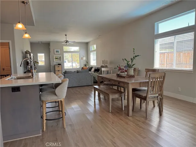 a view of a a dining room with furniture window and wooden floor