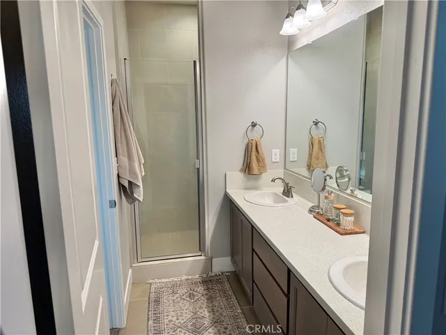 a bathroom with double vanity sink and a mirror