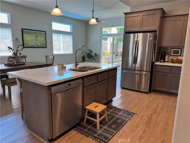 a kitchen with wooden cabinets and stainless steel appliances