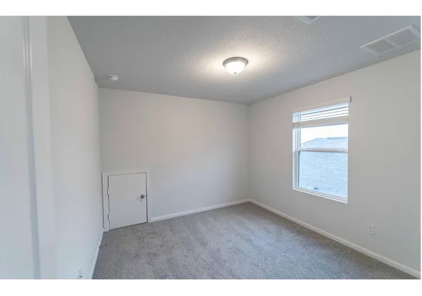 a view of an empty room and a window