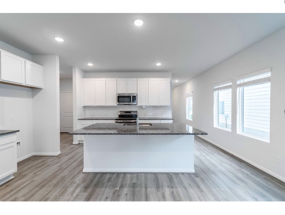 201 Lt. Rusty Jarrell, TX 76537 - Photo 3 of 14 a kitchen with stainless steel appliances granite countertop a refrigerator a sink dishwasher a stove and white countertops with wooden floor