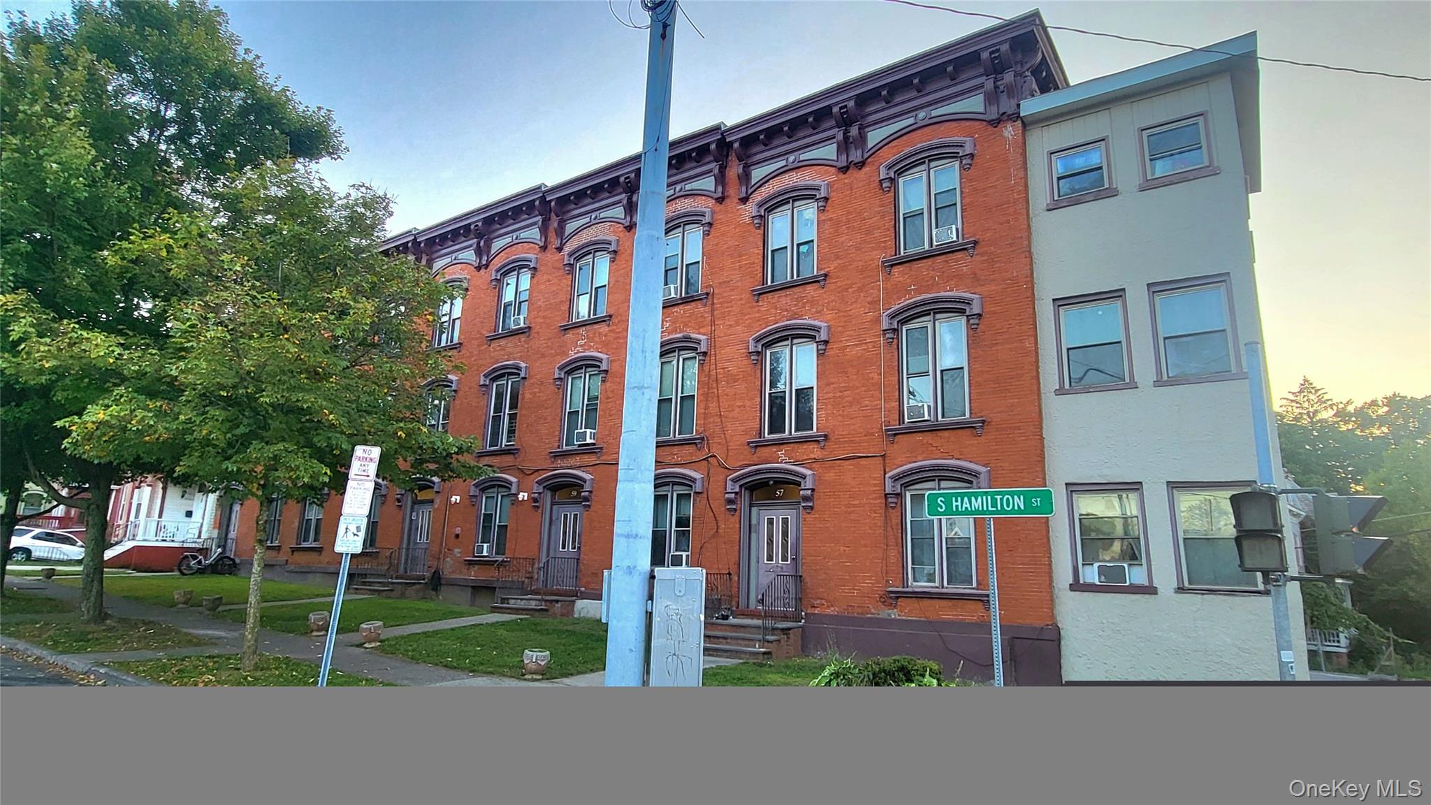 a view of a brick building next to a yard