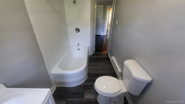 a white toilet sitting next to a bathroom sink