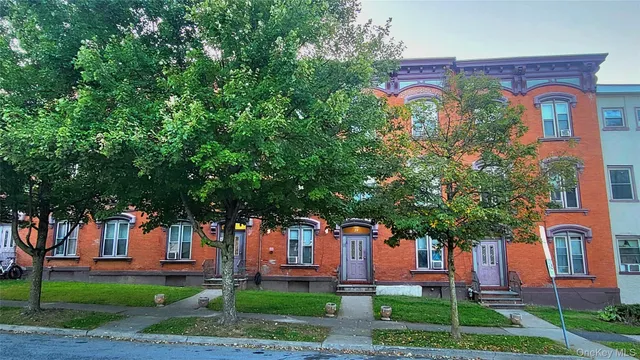 front view of a house with a tree