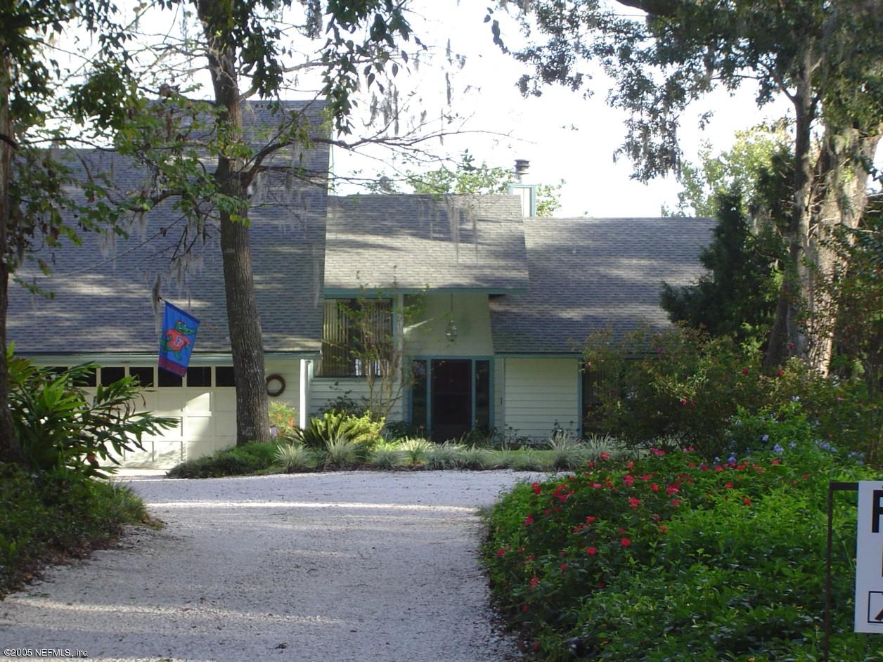 2900 Magnolia Road Orange Park, FL 32065 - Photo 5 of 6 a front view of a house with a yard and potted plants