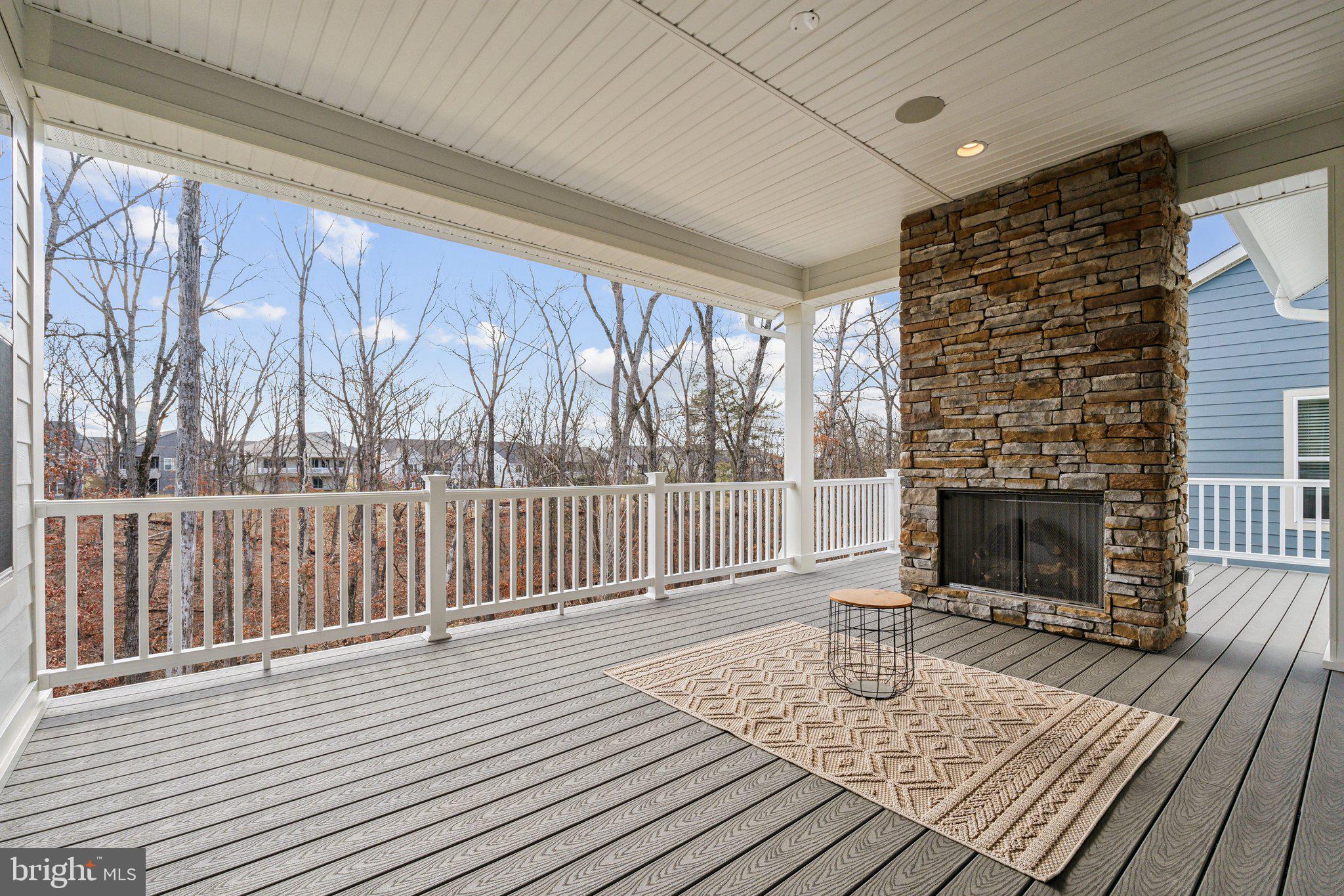 107 Bittern Ct Lake Front Royal, VA 22630 - Photo 17 of 65 a living room with a fireplace wooden floor and a rug