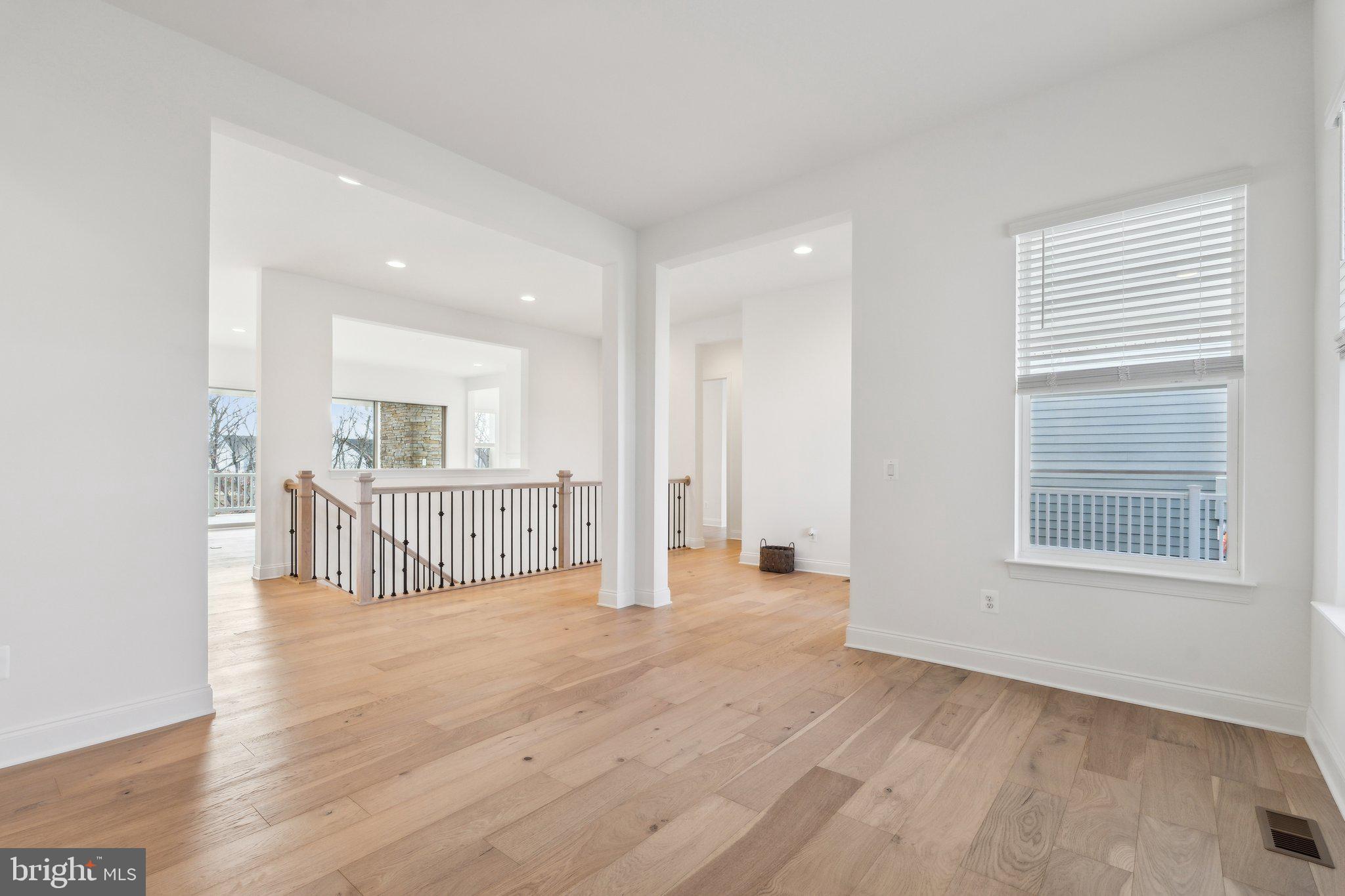 107 Bittern Ct Lake Front Royal, VA 22630 - Photo 8 of 65 a view of an empty room with wooden floor and a window