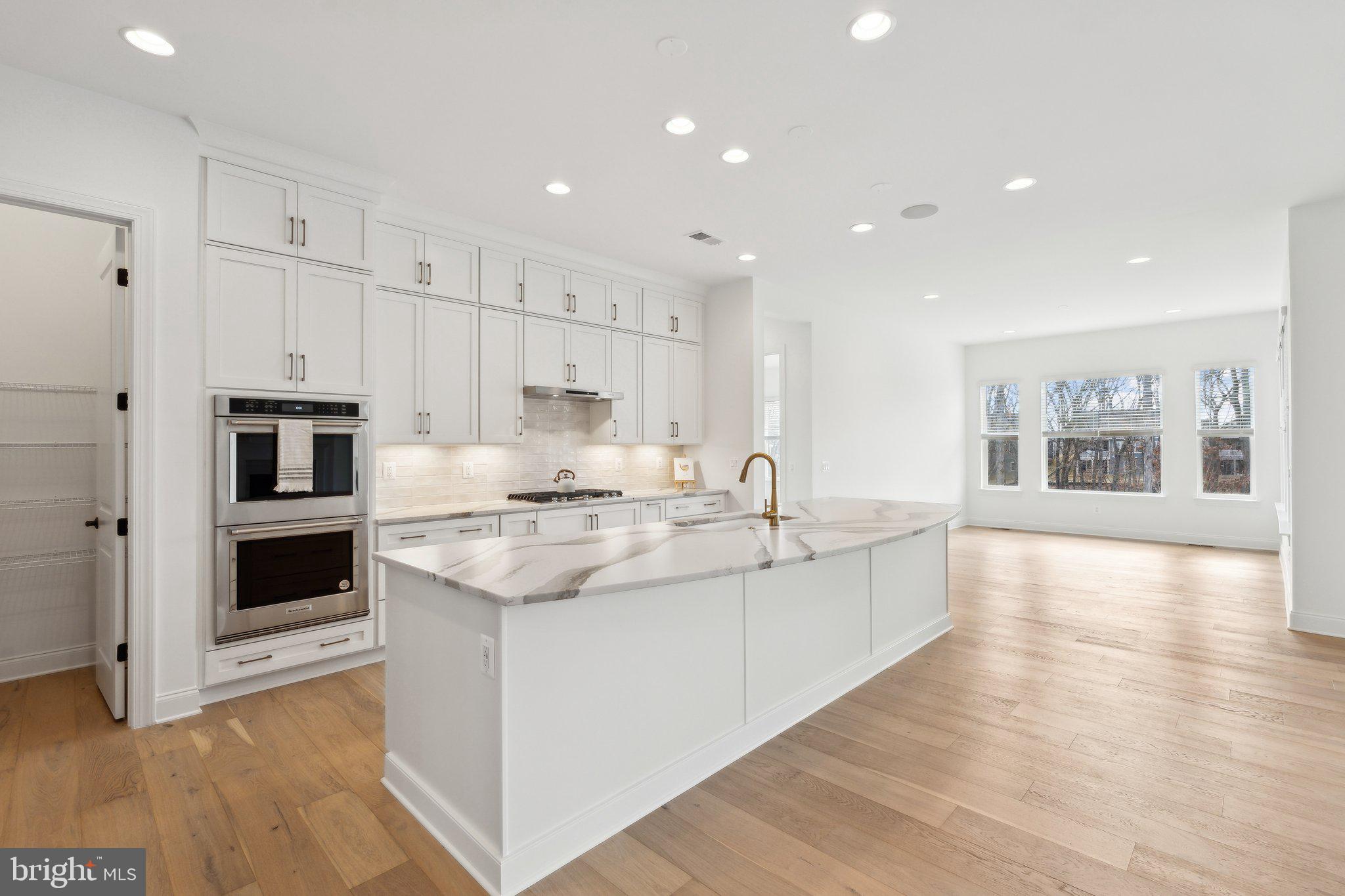 107 Bittern Ct Lake Front Royal, VA 22630 - Photo 10 of 65 a large kitchen with stainless steel appliances kitchen island a large counter top and a wooden floors