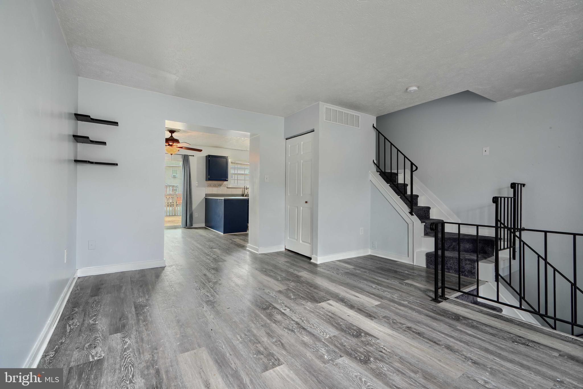 418 Kosoak Road Middle River, MD 21220 - Photo 3 of 25 a view of empty room with wooden floor and fireplace