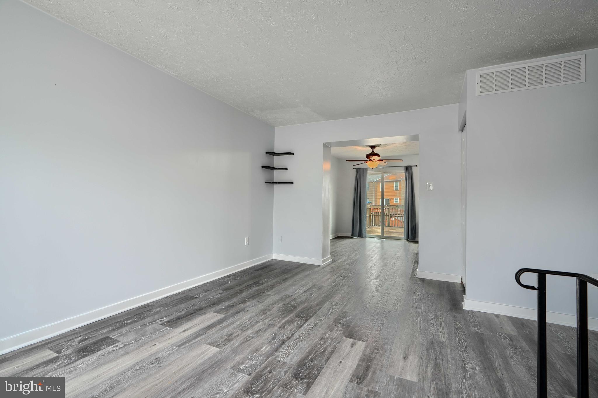 418 Kosoak Road Middle River, MD 21220 - Photo 4 of 25 a view of a big room with wooden floor and windows