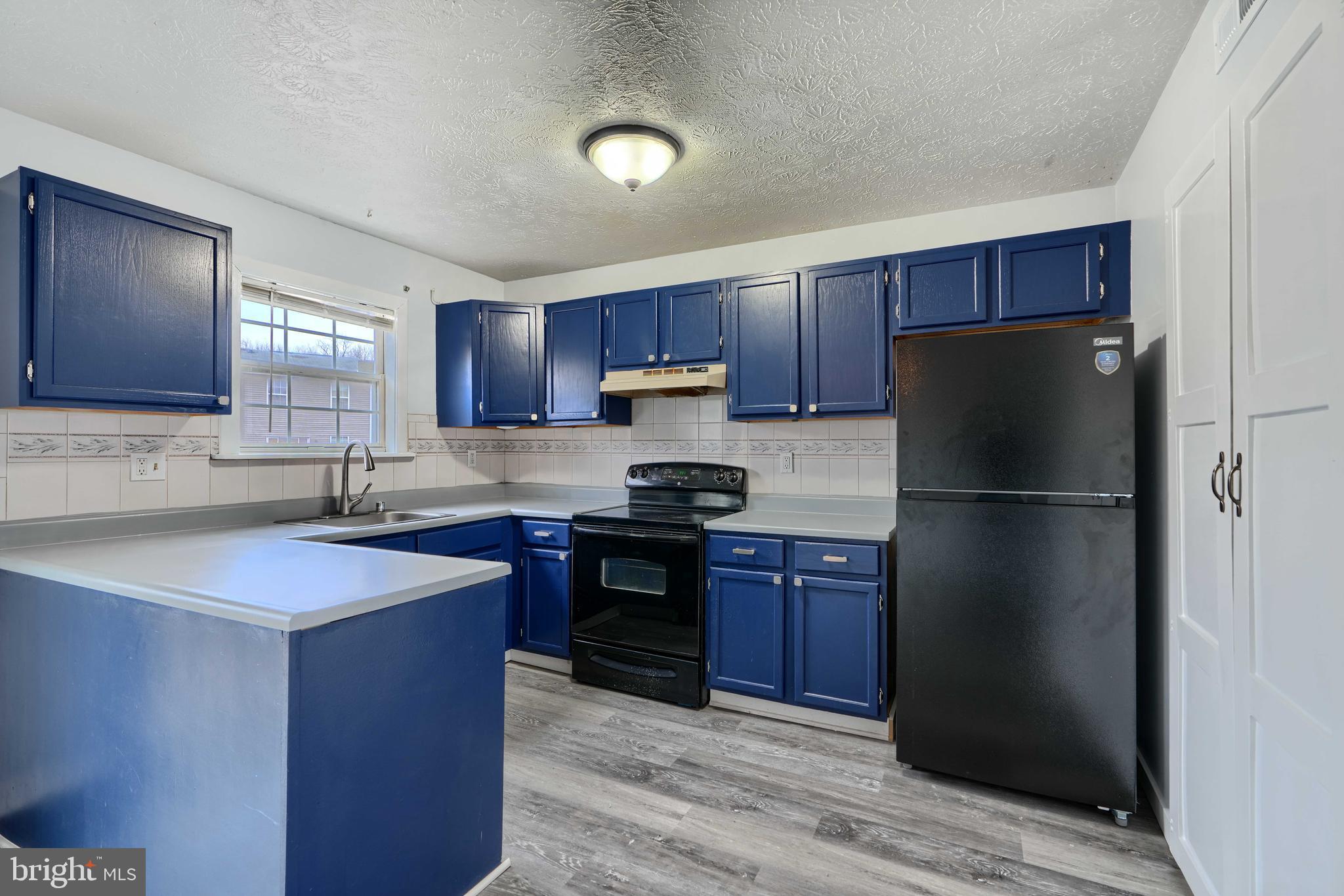 418 Kosoak Road Middle River, MD 21220 - Photo 7 of 25 a kitchen with stainless steel appliances granite countertop a refrigerator stove and sink