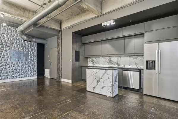 a view of an empty room with a kitchen