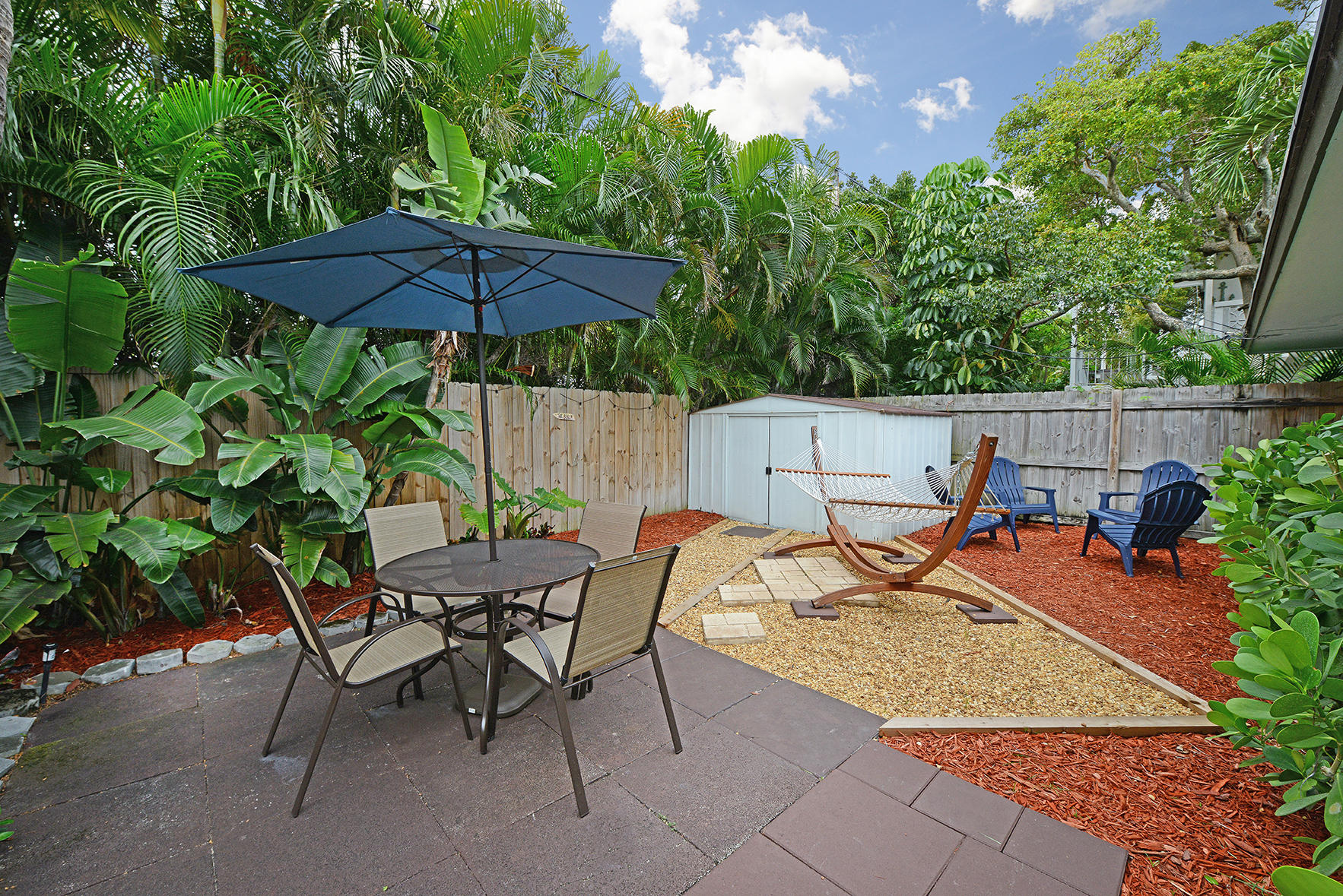 1257 Beach Road Singer Island, FL 33404 - Photo 13 of 71 a backyard of a house with table and chairs