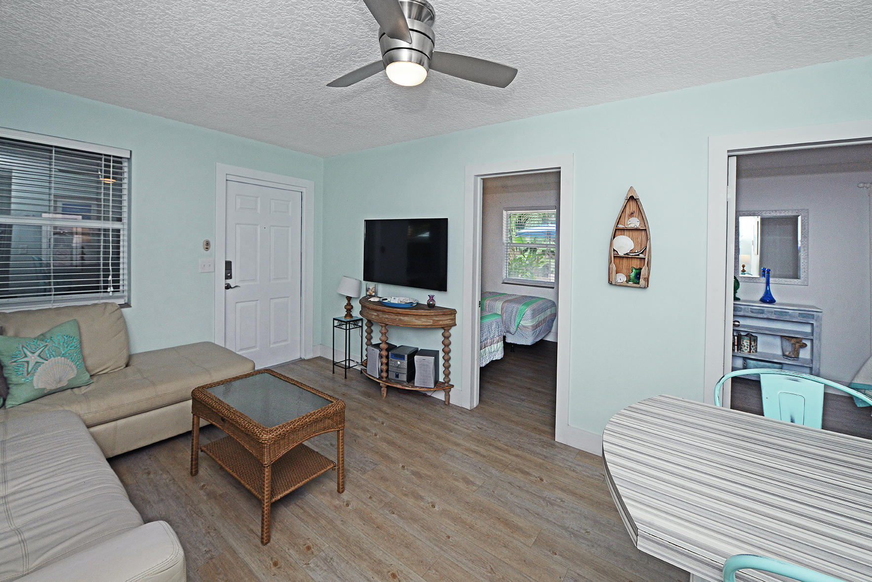 1257 Beach Road Singer Island, FL 33404 - Photo 18 of 71 a living room with furniture and a flat screen tv
