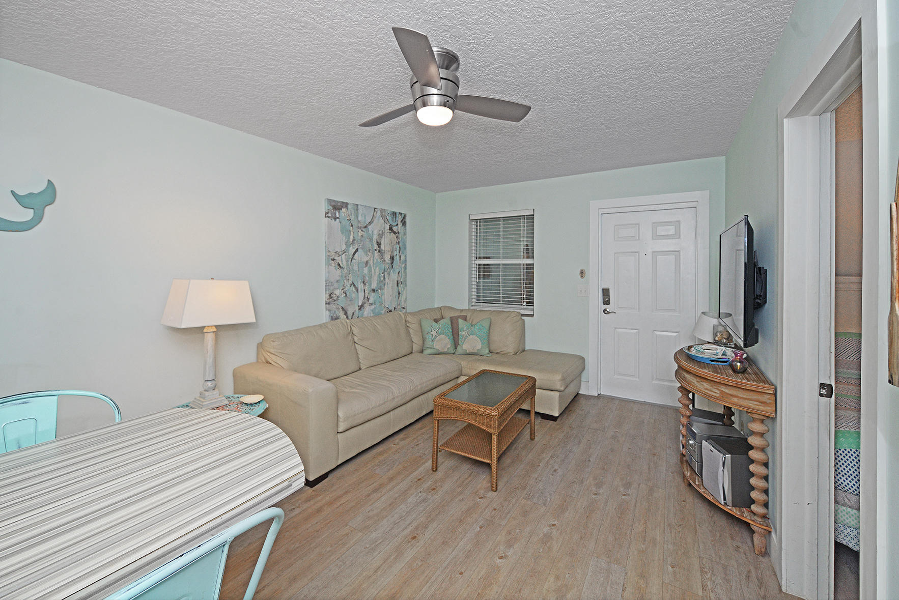 1257 Beach Road Singer Island, FL 33404 - Photo 19 of 71 a living room with furniture a flat screen tv and a window