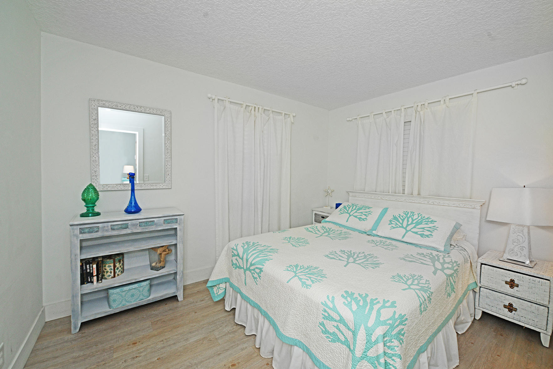 1257 Beach Road Singer Island, FL 33404 - Photo 22 of 71 a bedroom with a bed and a dresser in it