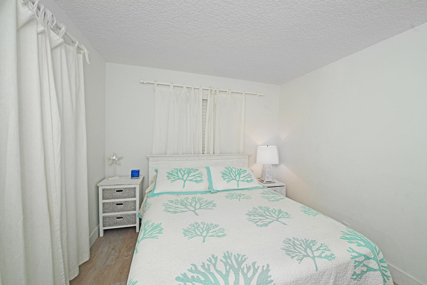 1257 Beach Road Singer Island, FL 33404 - Photo 23 of 71 a bedroom with a bed and a window