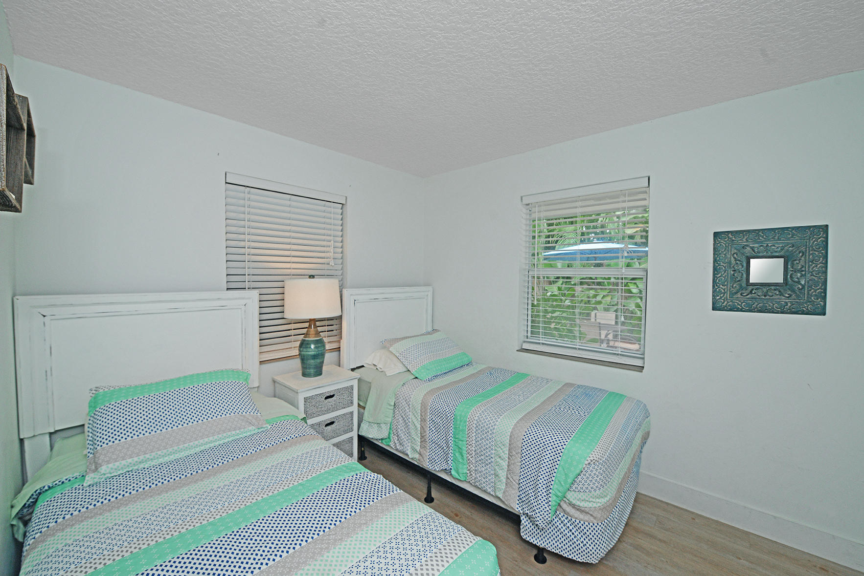 1257 Beach Road Singer Island, FL 33404 - Photo 24 of 71 a bedroom with two beds and a window