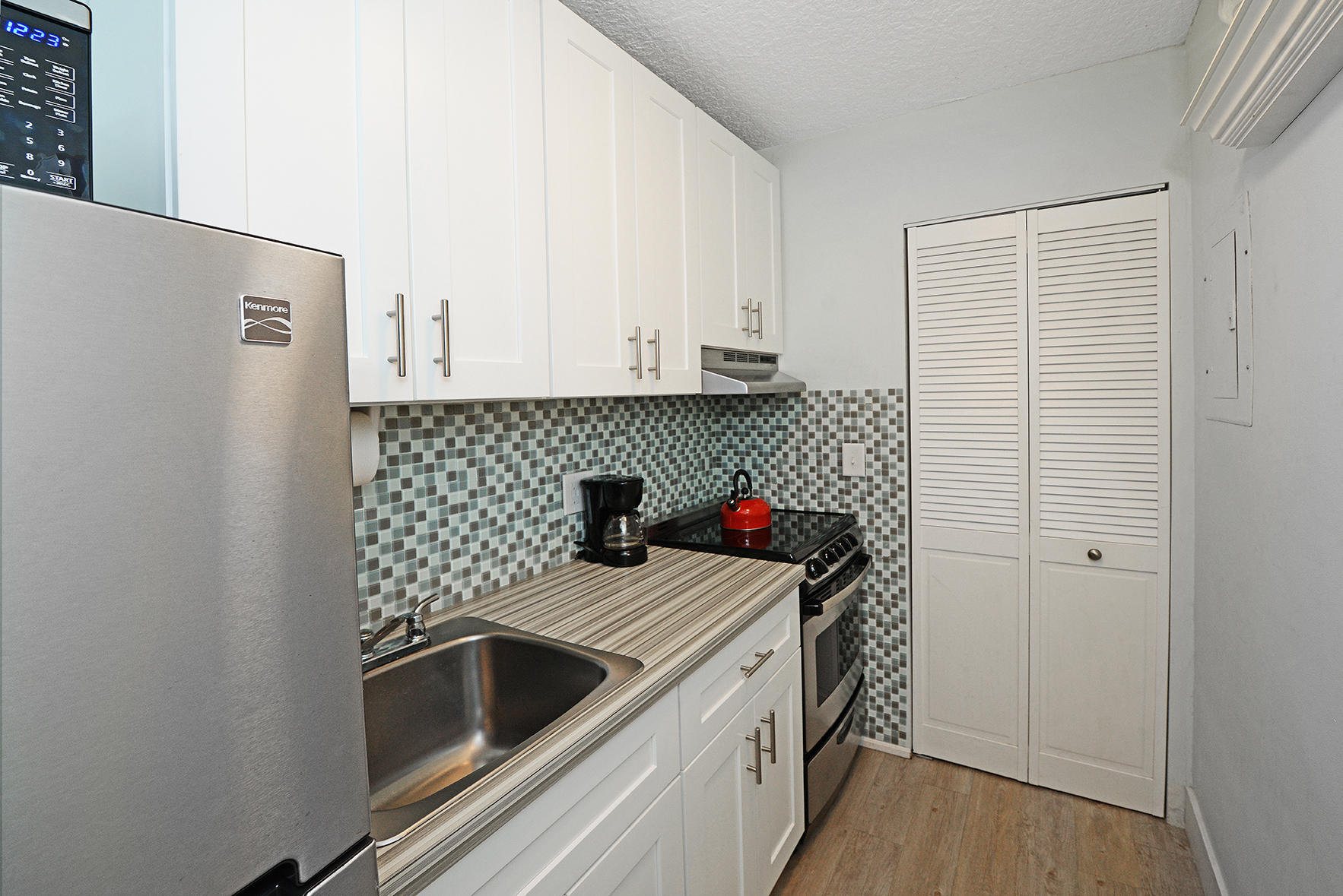 1257 Beach Road Singer Island, FL 33404 - Photo 26 of 71 a kitchen with a sink and a refrigerator
