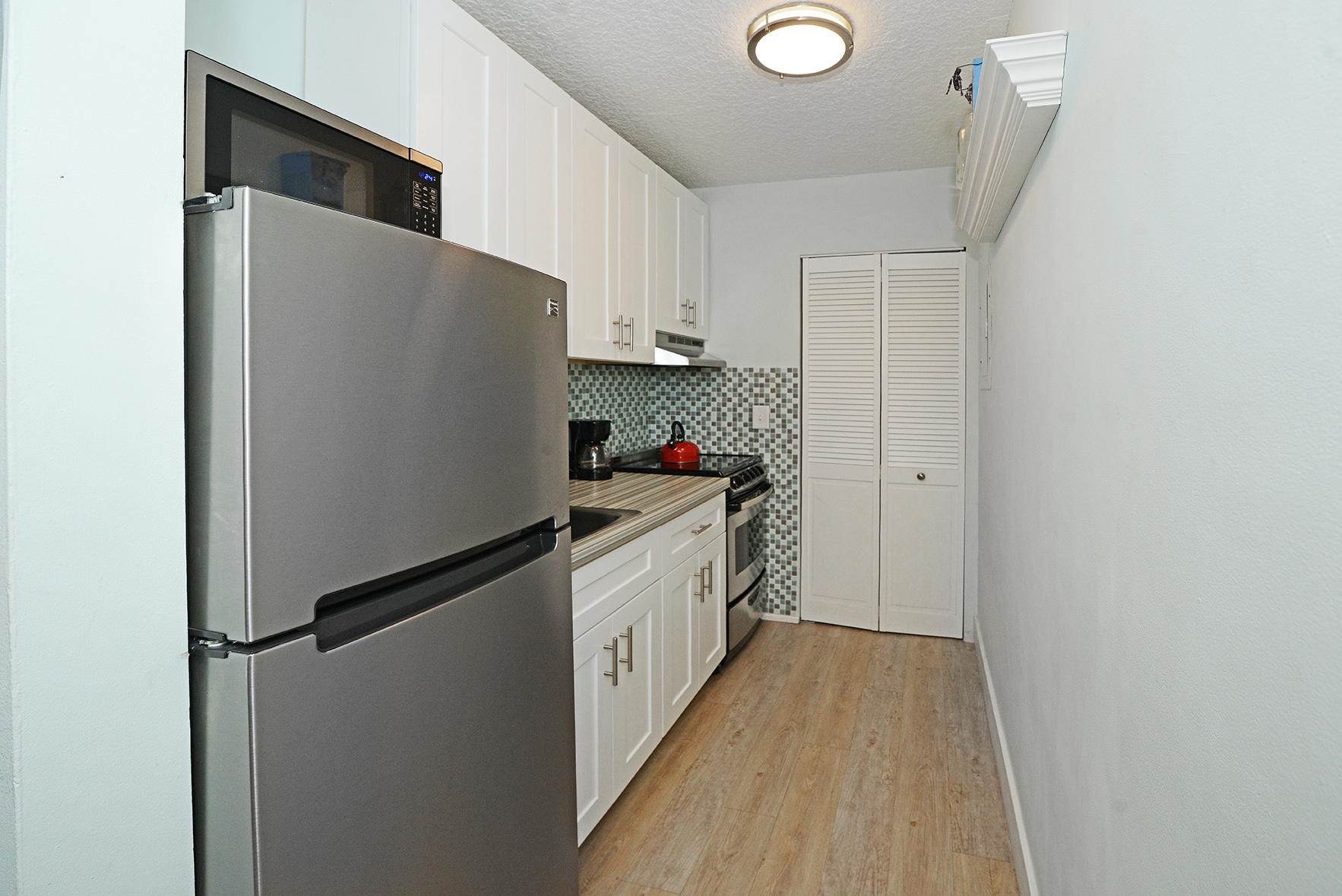 1257 Beach Road Singer Island, FL 33404 - Photo 28 of 71 a kitchen with stainless steel appliances a refrigerator and a stove