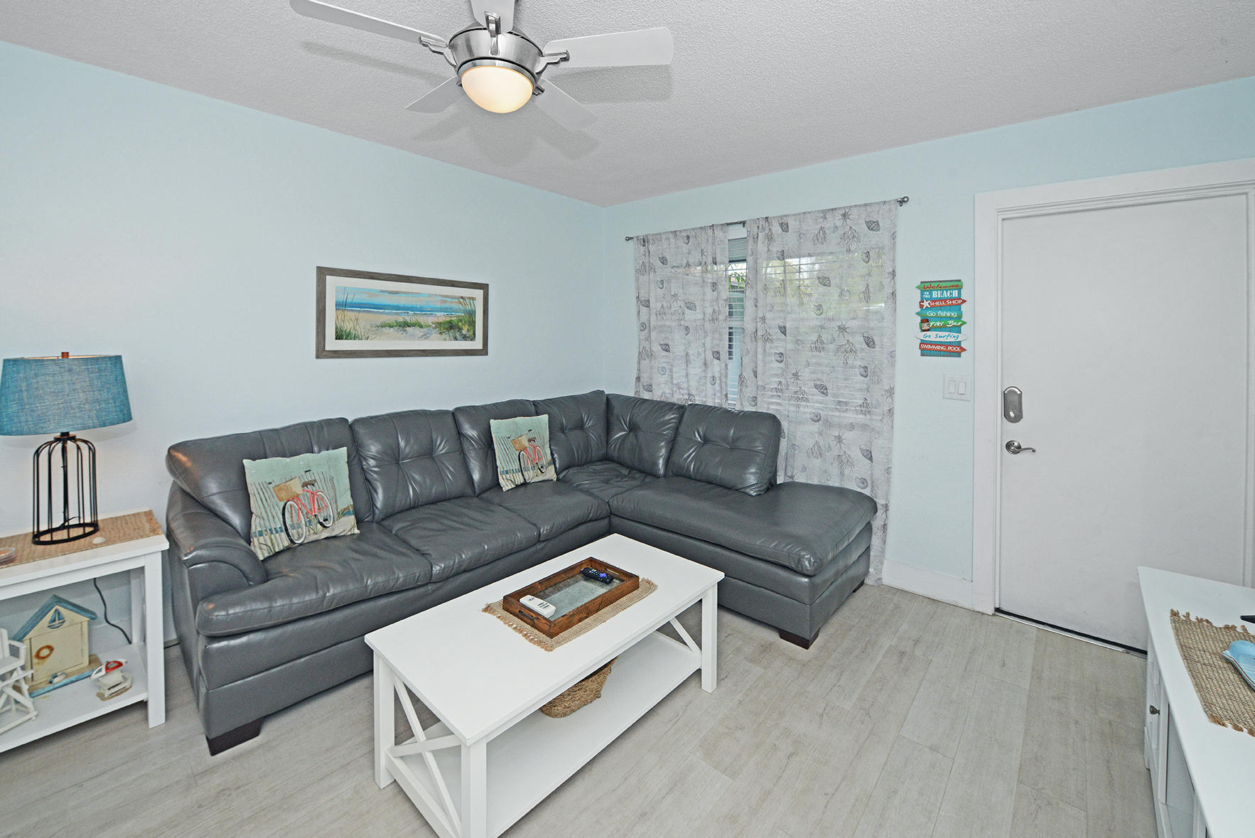 1257 Beach Road Singer Island, FL 33404 - Photo 34 of 71 a living room with furniture and a painting on the wall