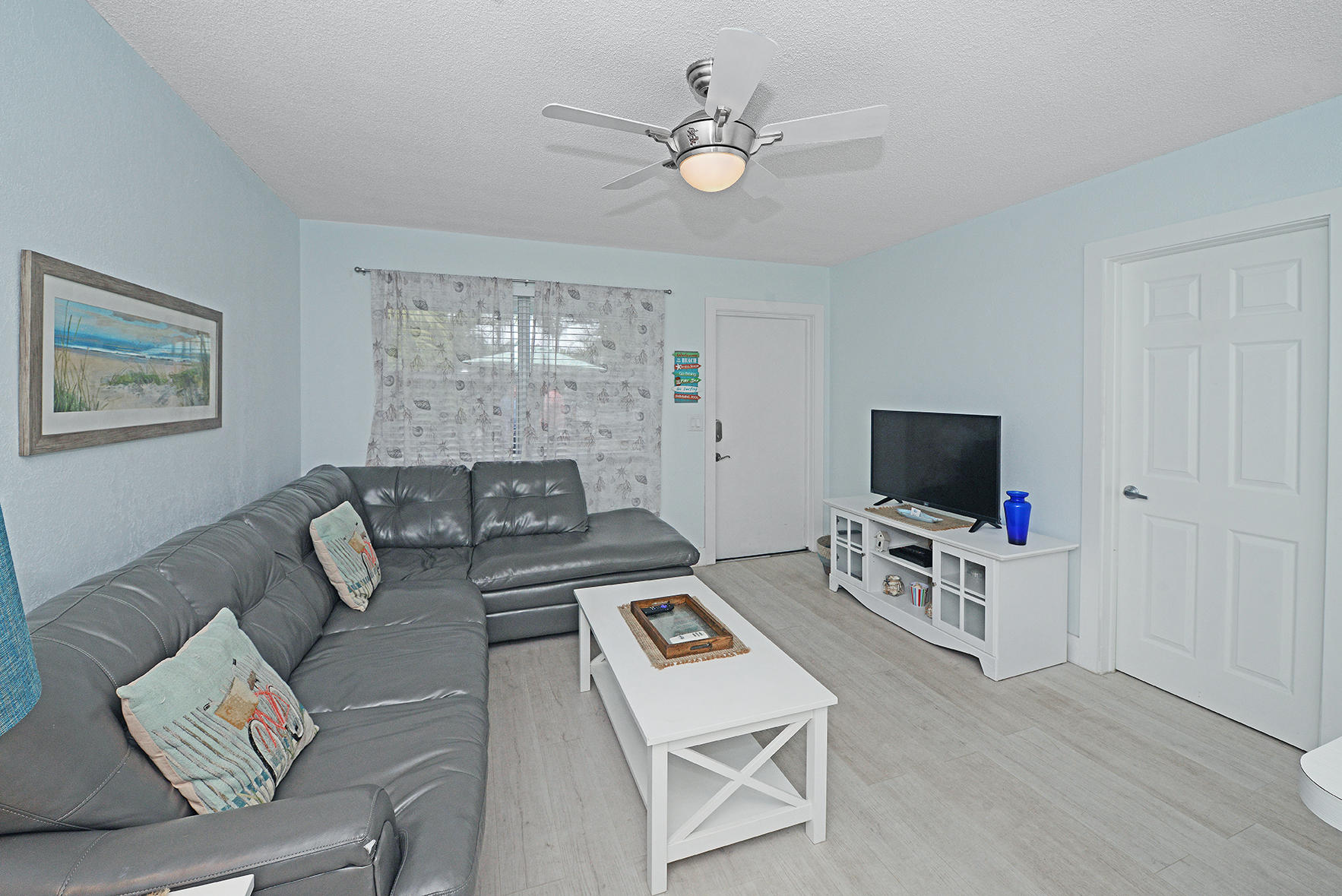 1257 Beach Road Singer Island, FL 33404 - Photo 35 of 71 a living room with furniture and a flat screen tv