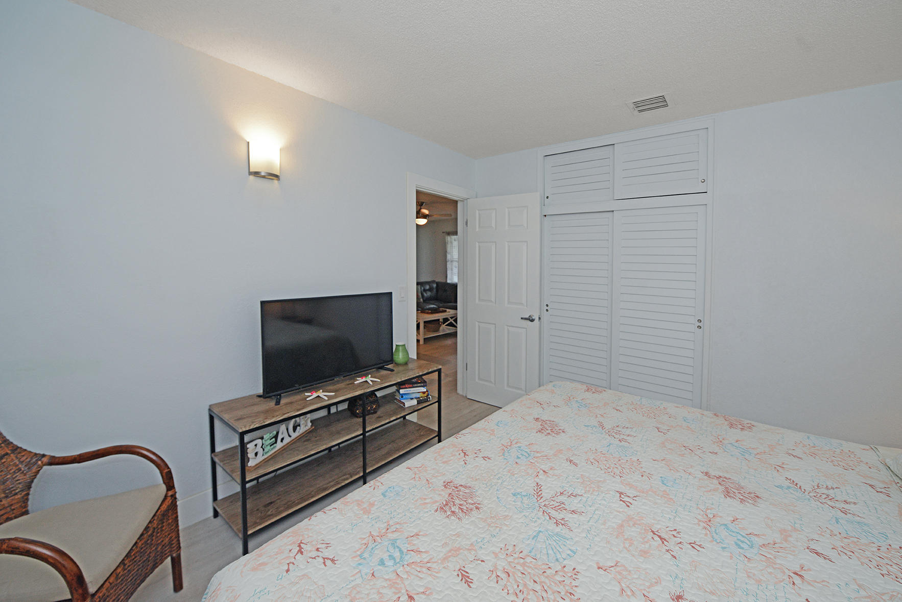 1257 Beach Road Singer Island, FL 33404 - Photo 40 of 71 a bedroom with a bed and a flat screen tv