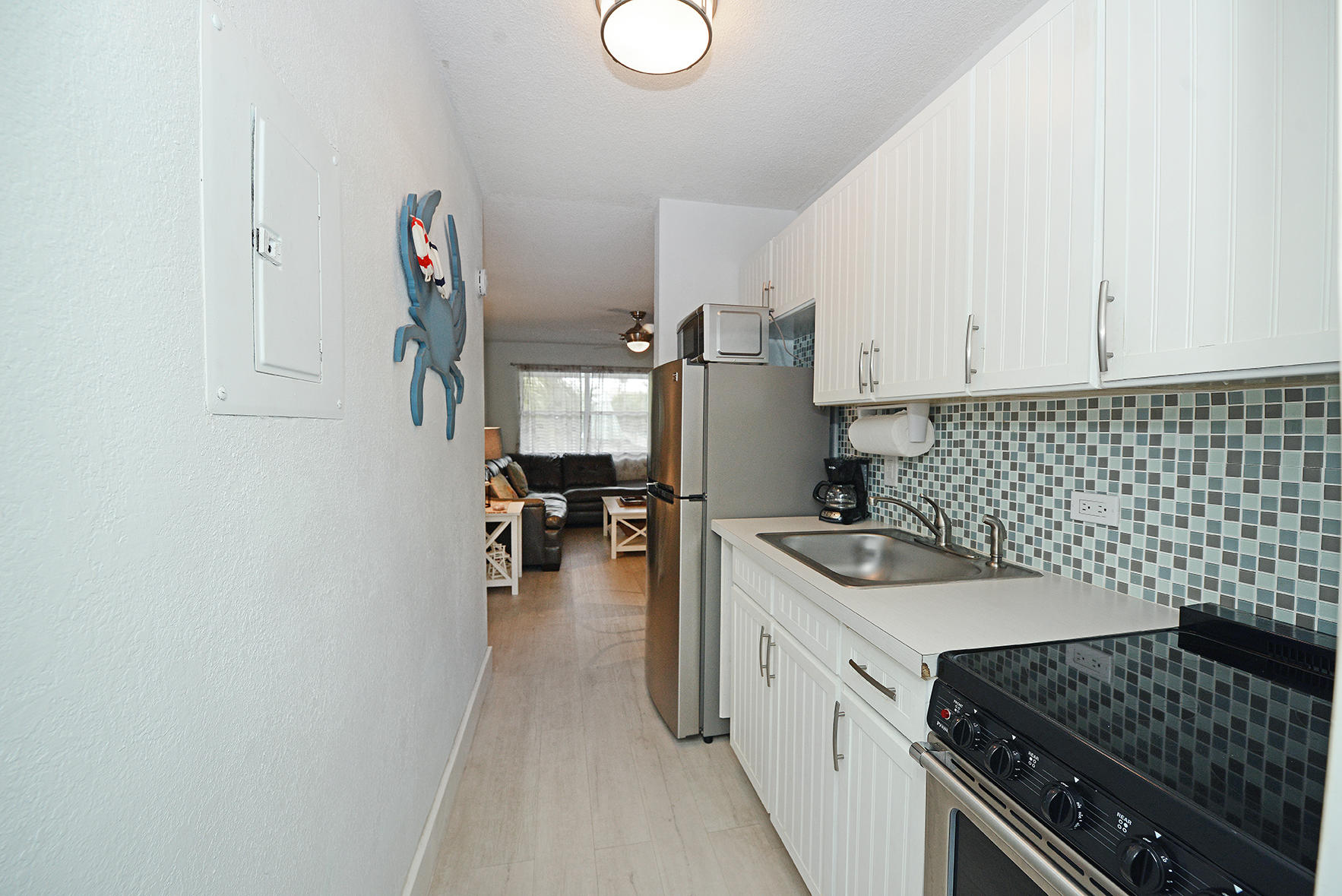 1257 Beach Road Singer Island, FL 33404 - Photo 45 of 71 a kitchen with sink and cabinets