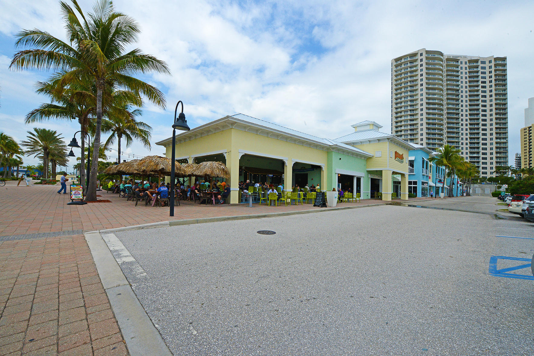 1257 Beach Road Singer Island, FL 33404 - Photo 53 of 71 a group of people sitting in front of a building