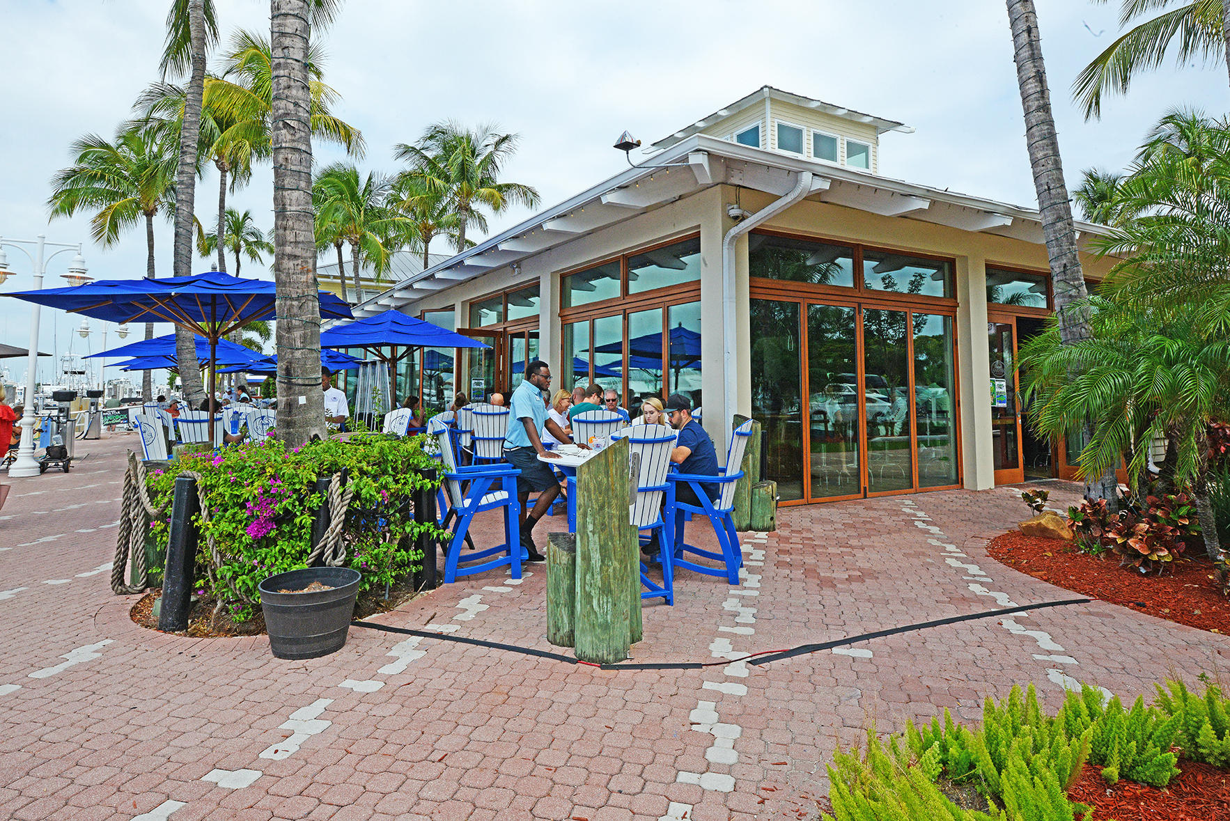 1257 Beach Road Singer Island, FL 33404 - Photo 59 of 71 a view of the patio with dining table and chairs under an umbrella