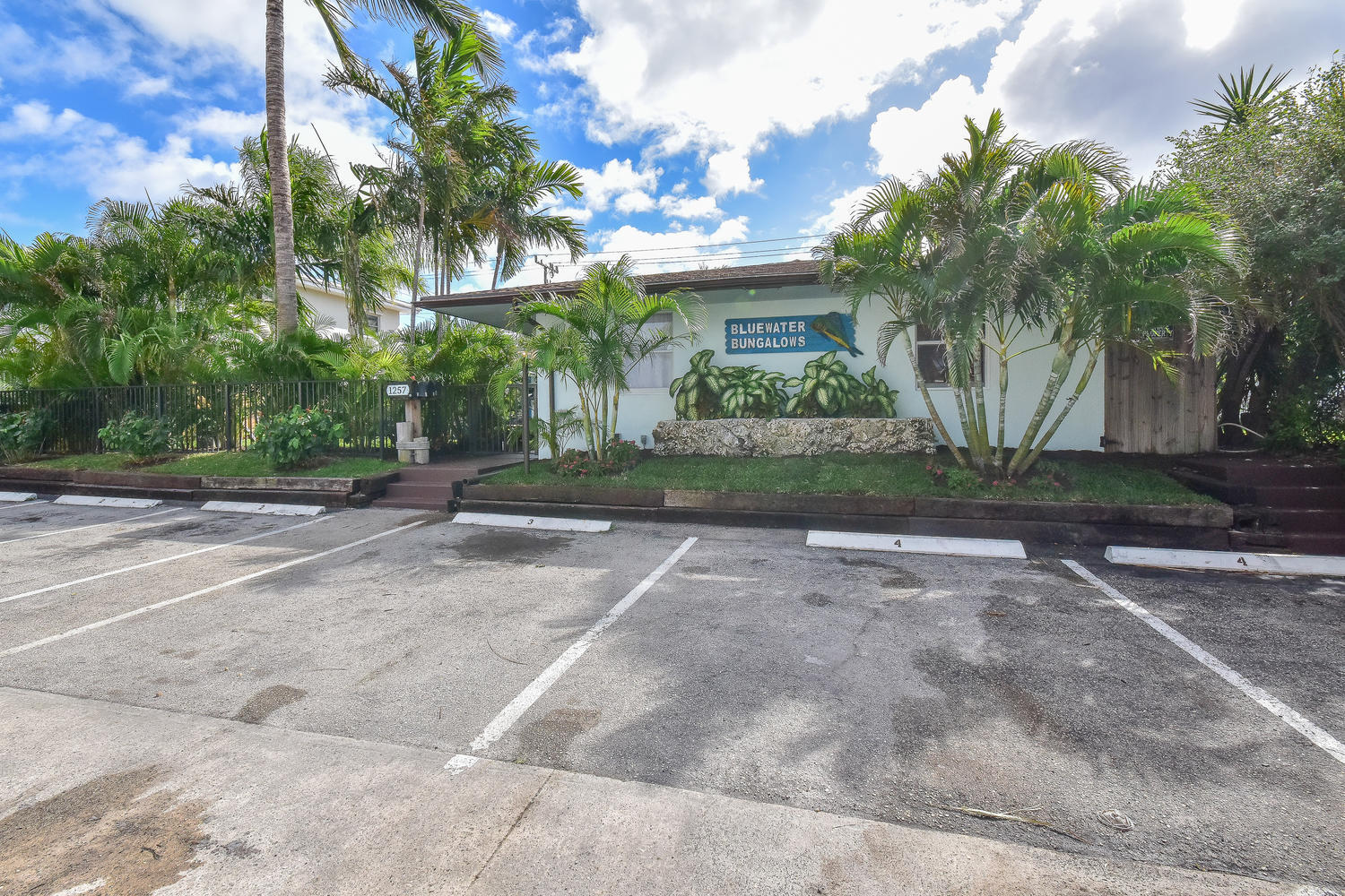 1257 Beach Road Singer Island, FL 33404 - Photo 62 of 71 a front view of a house with a yard and a garage