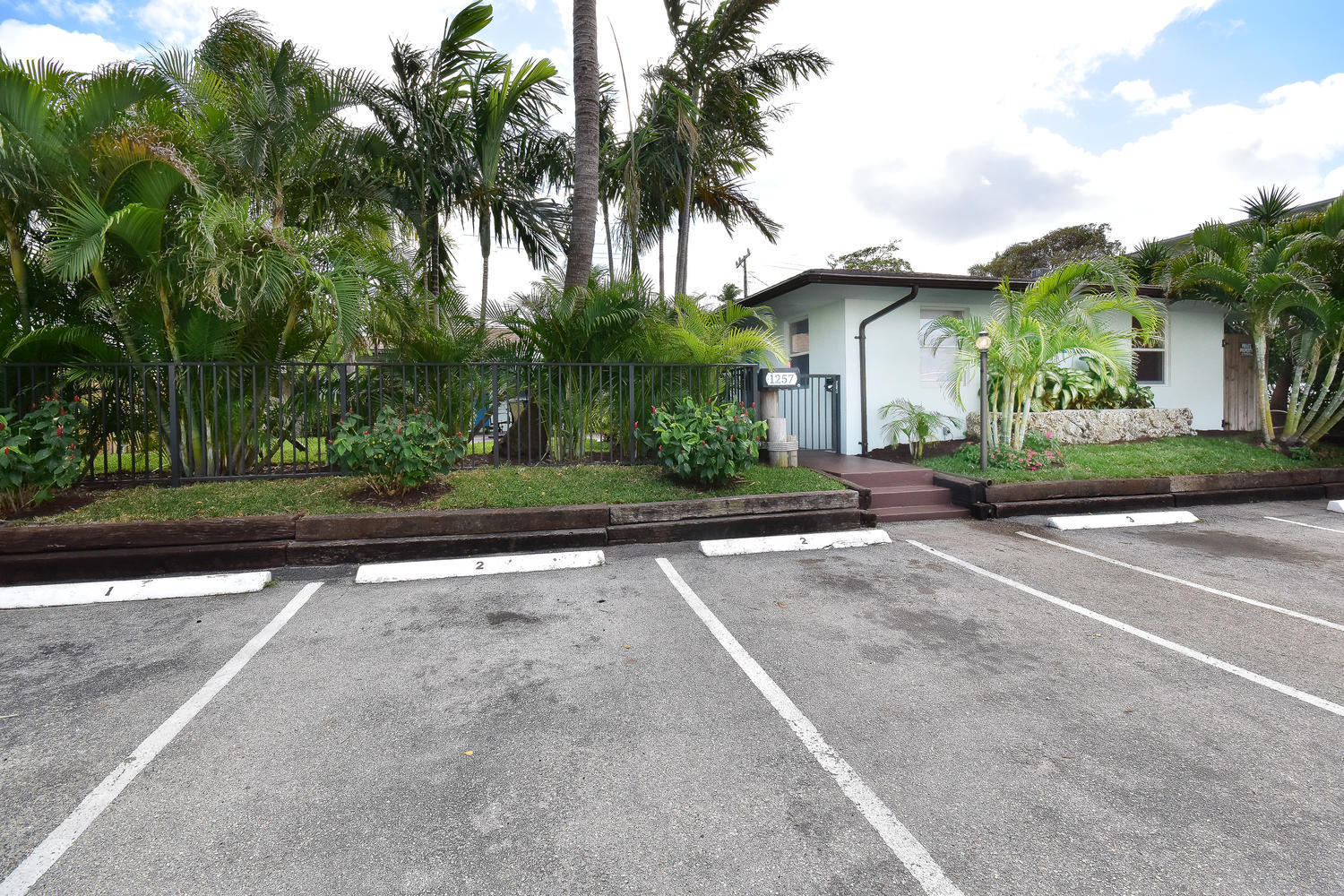 1257 Beach Road Singer Island, FL 33404 - Photo 63 of 71 front view of a house with a garden