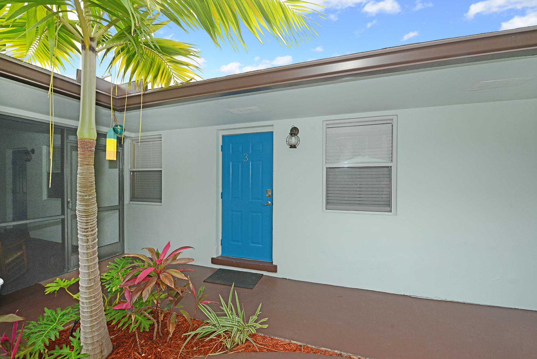 1257 Beach Road Singer Island, FL 33404 - Photo 7 of 71 a potted plant sitting in front of a door