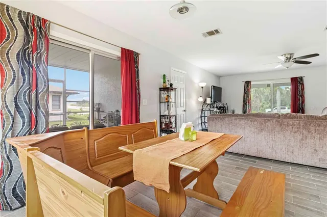 a dining room with furniture and wooden floor