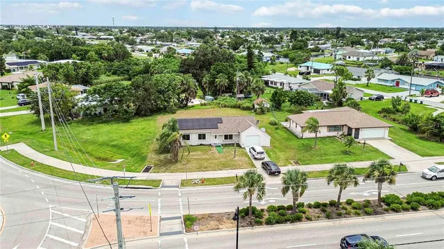 an aerial view of residential houses with outdoor space and street view