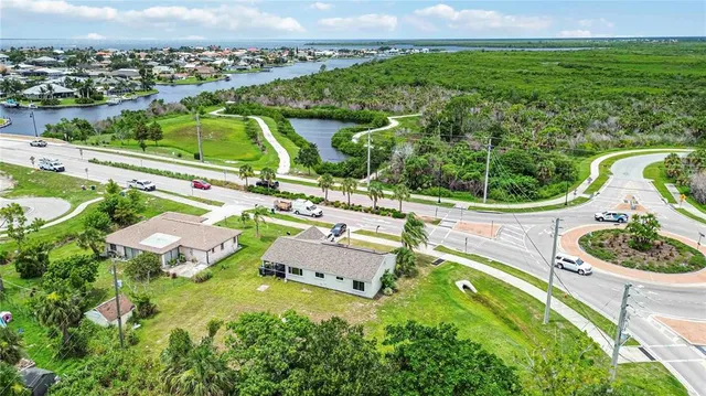 an aerial view of residential houses with outdoor space and street view