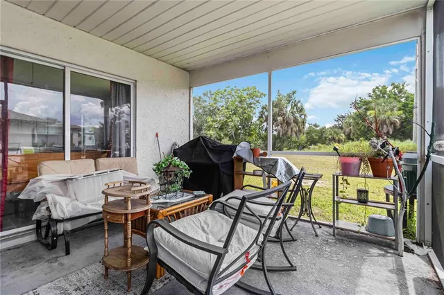 a dining room with furniture and a potted plant