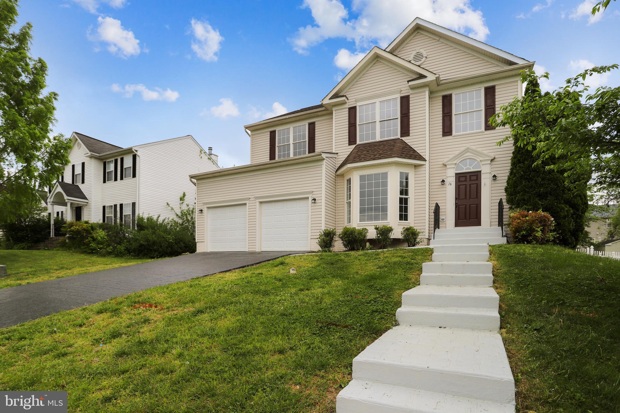 16 Sunset Ridge Lane Fredericksburg, VA 22405 - Photo 2 of 35 a front view of a house with a yard and garage