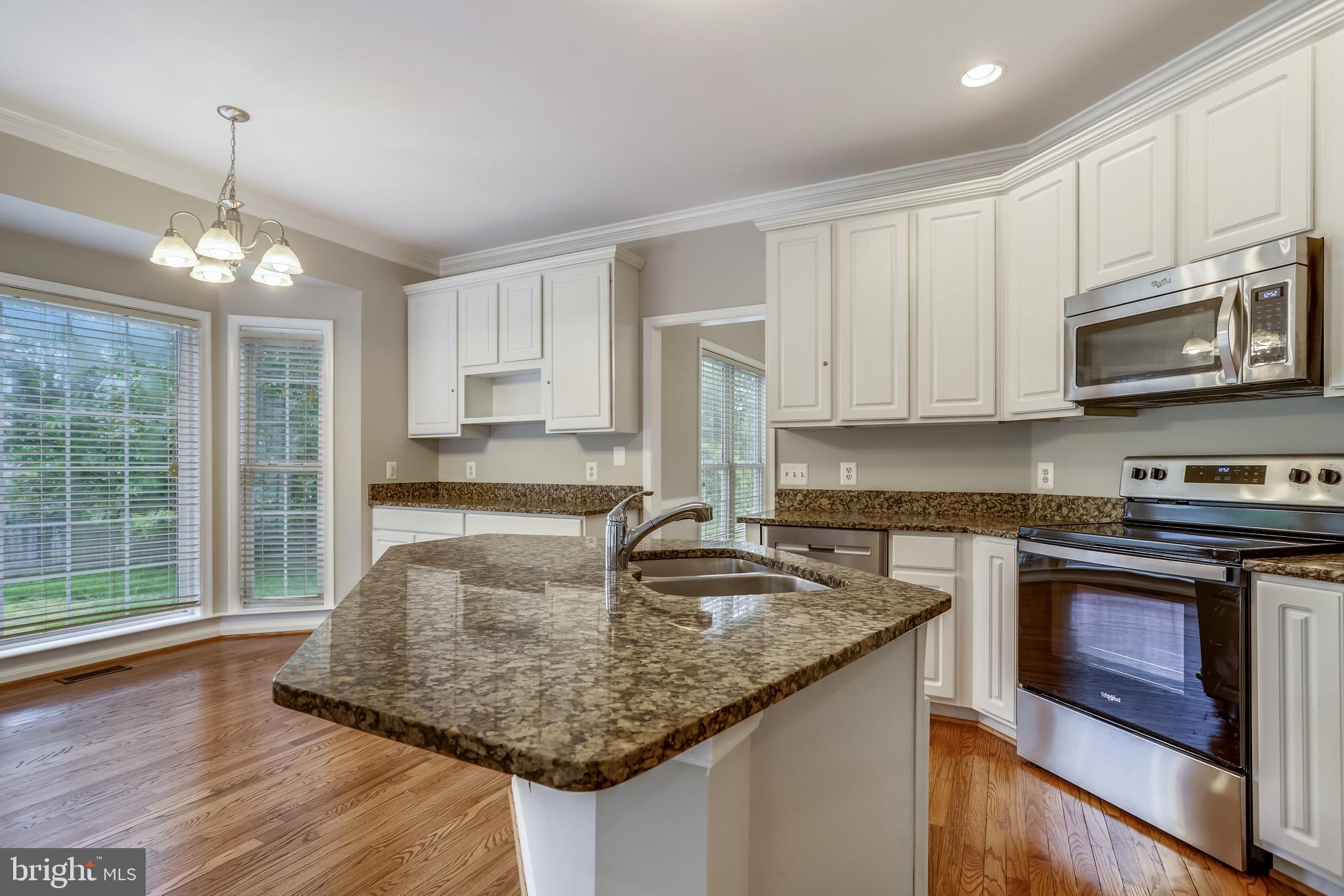 16 Sunset Ridge Lane Fredericksburg, VA 22405 - Photo 10 of 35 a kitchen with stainless steel appliances granite countertop a sink stove and microwave