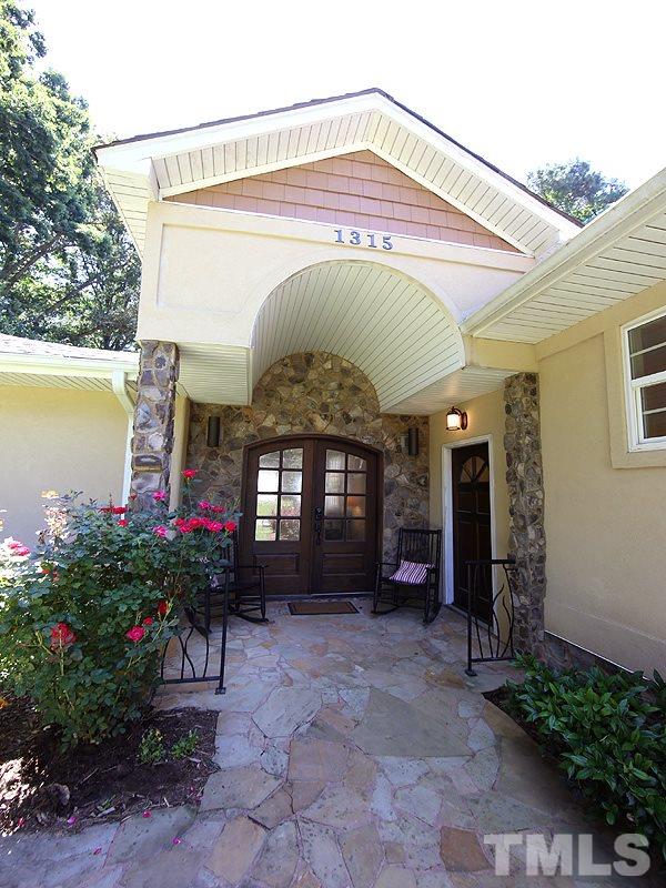 1315 Chaney Road Raleigh, NC 27606 - Photo 2 of 25 Stone walkway to double-door front covered entry.