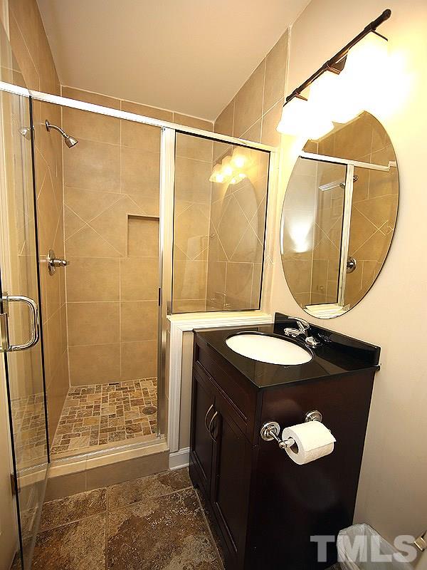 1315 Chaney Road Raleigh, NC 27606 - Photo 17 of 25 As part of the addition, this full bath boasts an all tile walk-in shower.