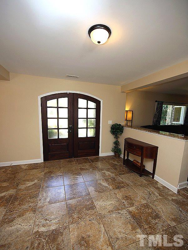 1315 Chaney Road Raleigh, NC 27606 - Photo 3 of 25 Wide entry foyer boasts tile flooring and smooth ceilings throughout.