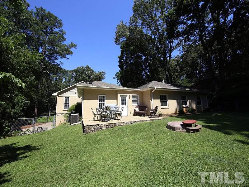 1315 Chaney Road Raleigh, NC 27606 - Photo 24 of 25 Enjoy the stone patio overlooking the private, fenced backyard.