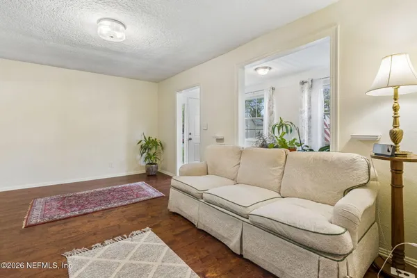 a living room with furniture and a potted plant