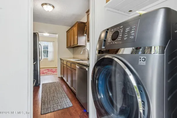 a view of a hallway with washer and dryer