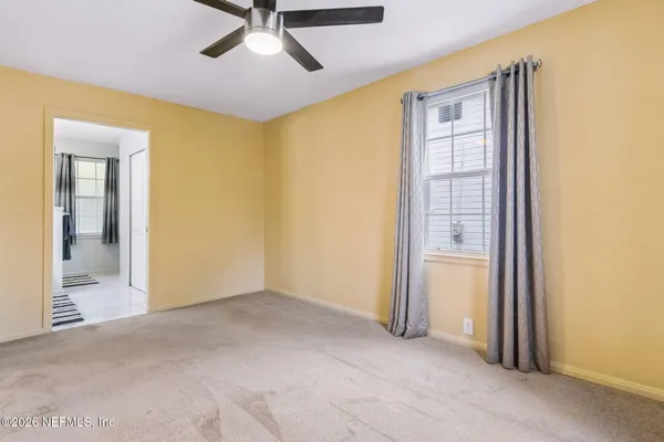 an empty room and chandelier fan